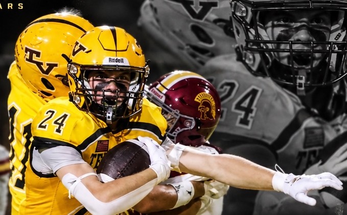 Deven Krause running with the football in a gold uniform